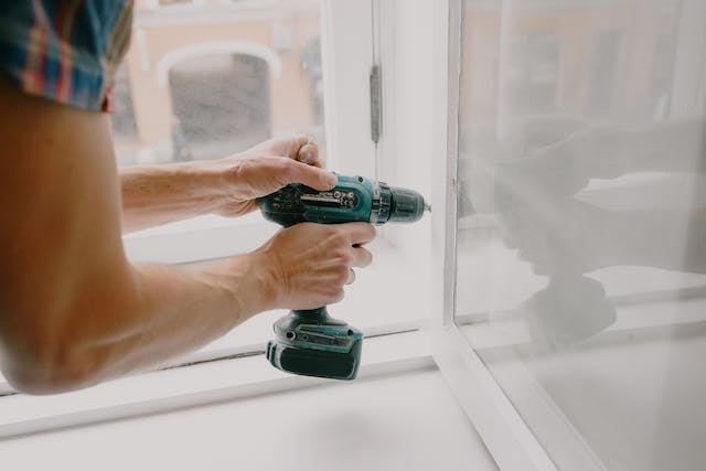 person drilling a window